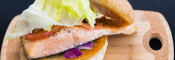 Baked salmon burger with lettuce, curry tomato, red onion, and aioli Gary Lum