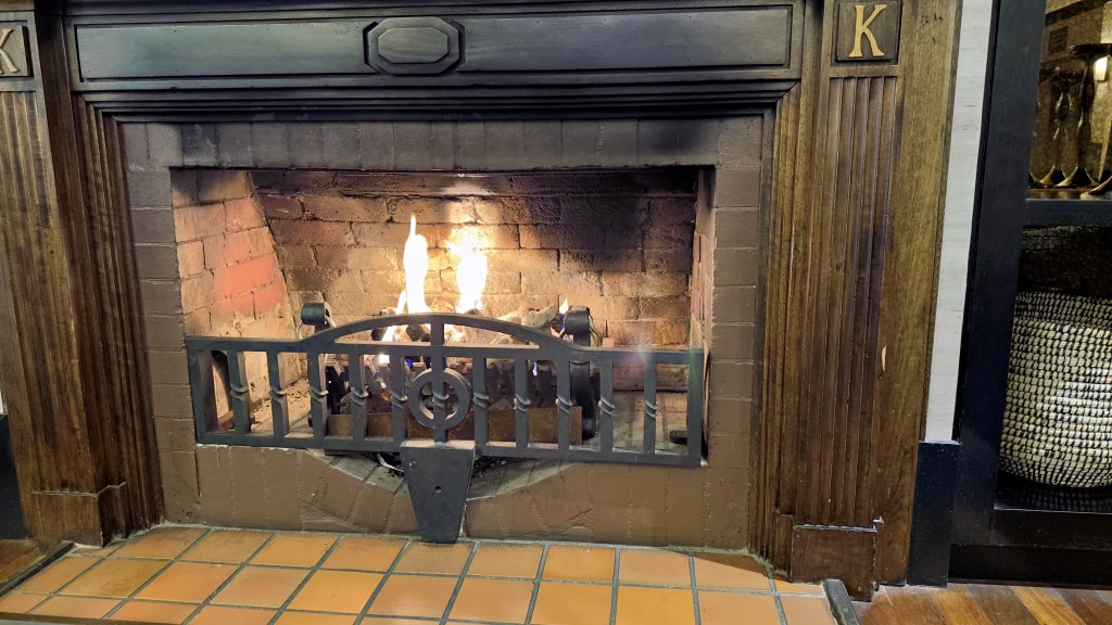 A photograph of a fire in the fireplace of the Hotel Kurrajong.