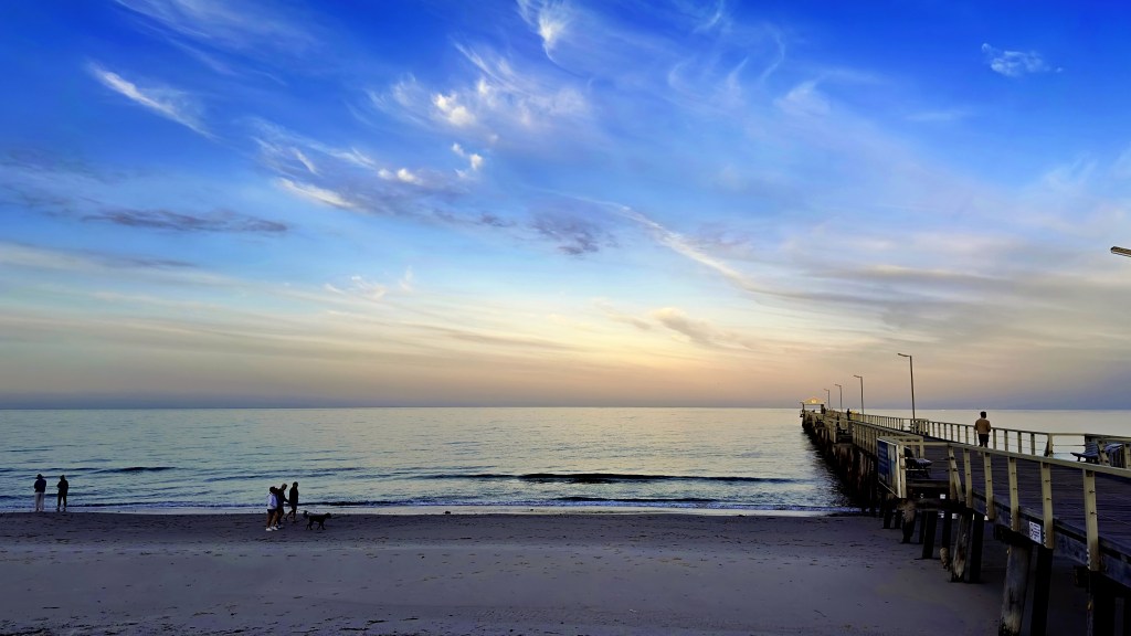 A sunrise photograph of the Indian Ocean facing west from Henley Beach with the Henley Beach Jetty on the right.