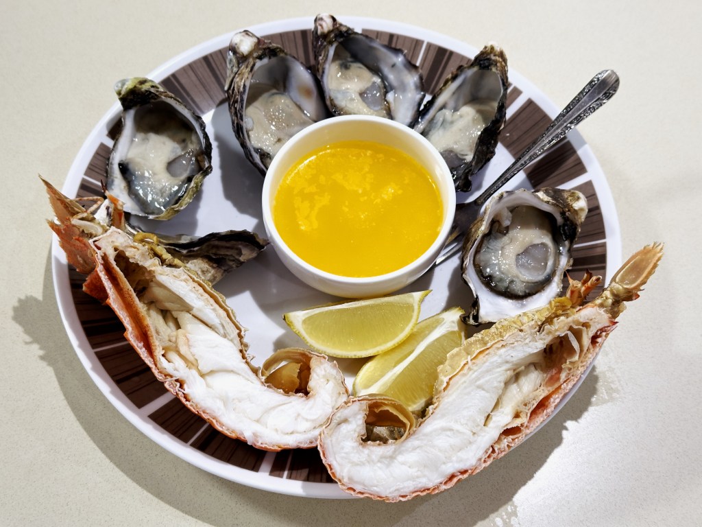 Photograph of Morgan's Seafood Large Pacific Oysters and Moreton Bay Bug with a pot of melted butter.