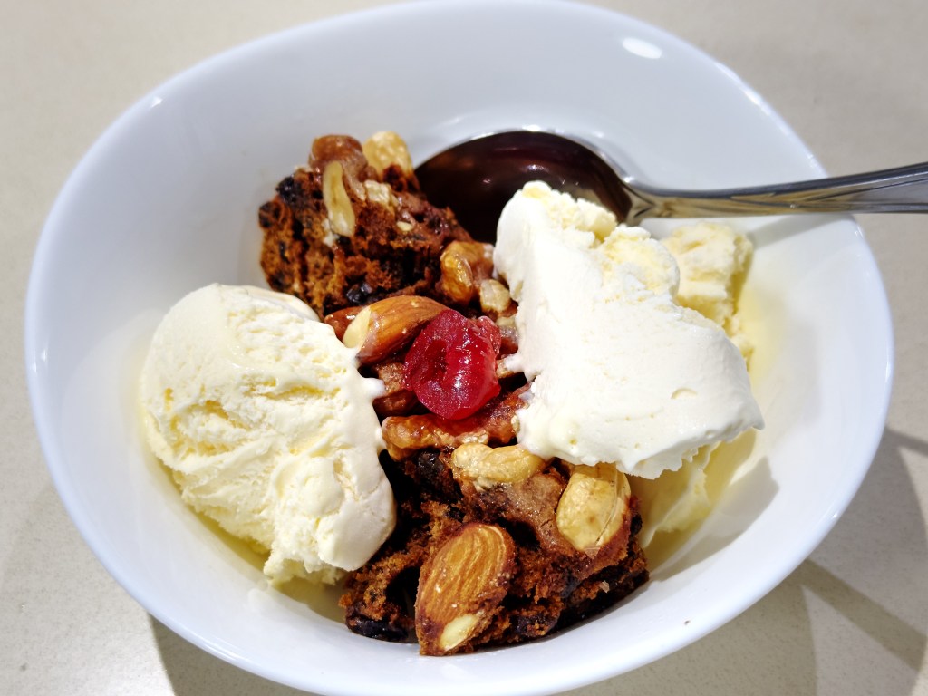 Photograph of warmed Perryman's Bakery Christmas cake and vanilla ice cream