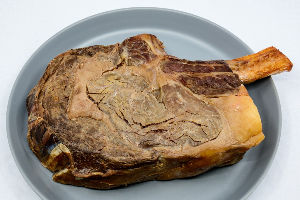 Photograph of Bone-in ribeye steak out of the water bath prior to being seared.