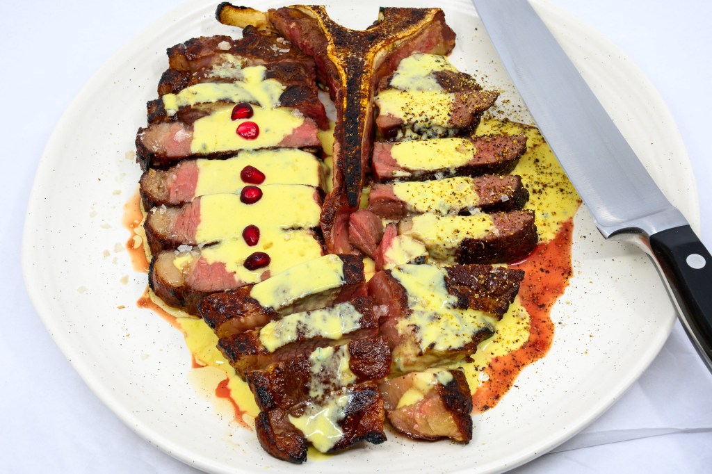T-bone steak with blue vein cheese and mustard sauce with pomegranate arils