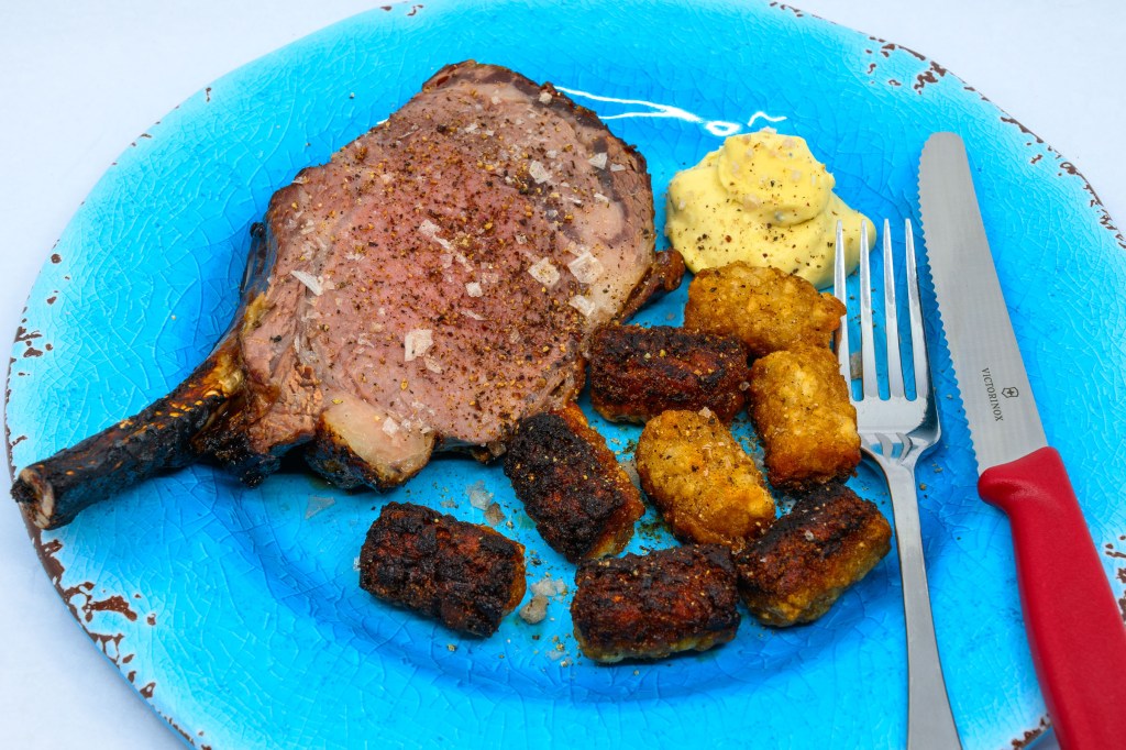 Carved standing rib roast with potato gems and blue vein cheese and mustard sauce