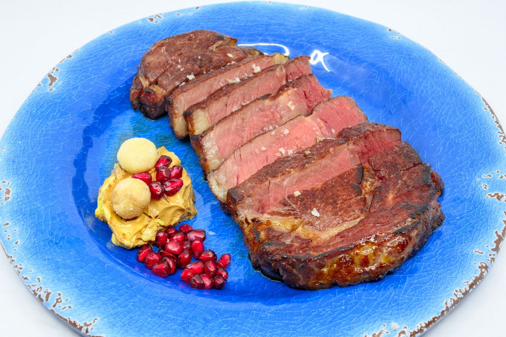 Grass-fed scotch fillet steak with whipped Vegemite butter, a couple of Queensland nuts, and some pomegranate arils.