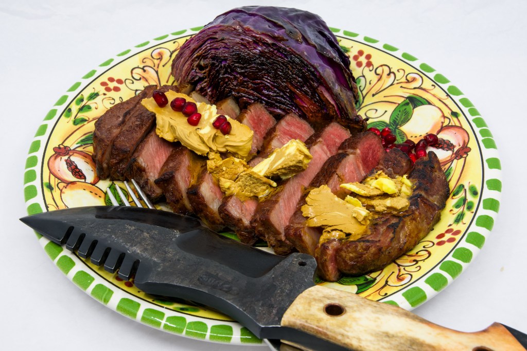 Grass-fed scotch fillet steak, red cabbage, whipped Vegemite butter, and pomegranate arils