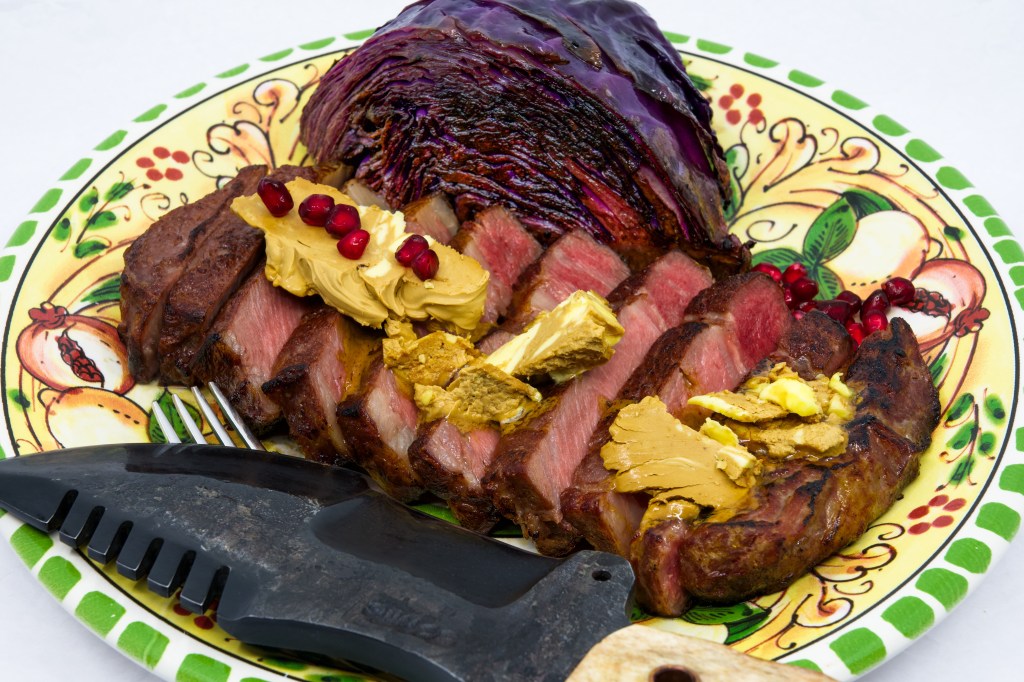 Grass-fed scotch fillet steak, red cabbage, whipped Vegemite butter, and pomegranate arils