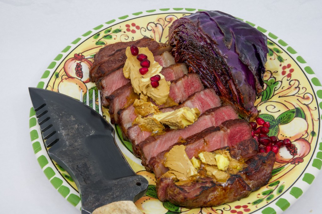 Grass-fed scotch fillet steak, red cabbage, whipped Vegemite butter, and pomegranate arils