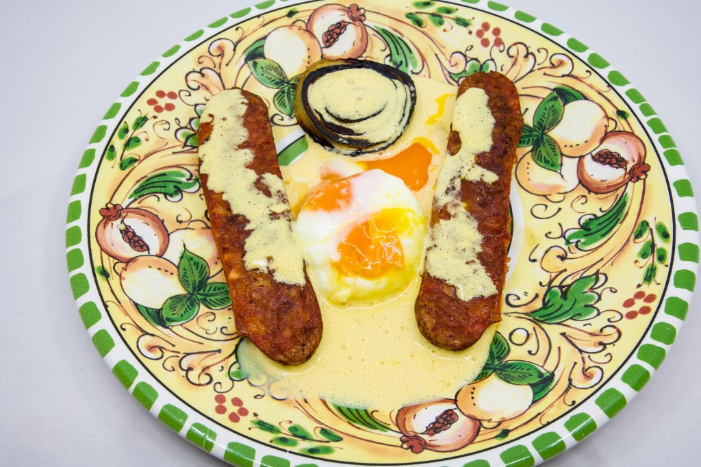 Democracy sausage, cooked in the Weber Q+ with some white onion, was served with a couple of poached eggs and freshly made Hollandaise sauce. The sauce was delicious, made with three egg yolks, freshly squeezed lemon juice Vegemite and melted salted butter. However, the poached egg yolks broke prematurely creating a mess on the plate.