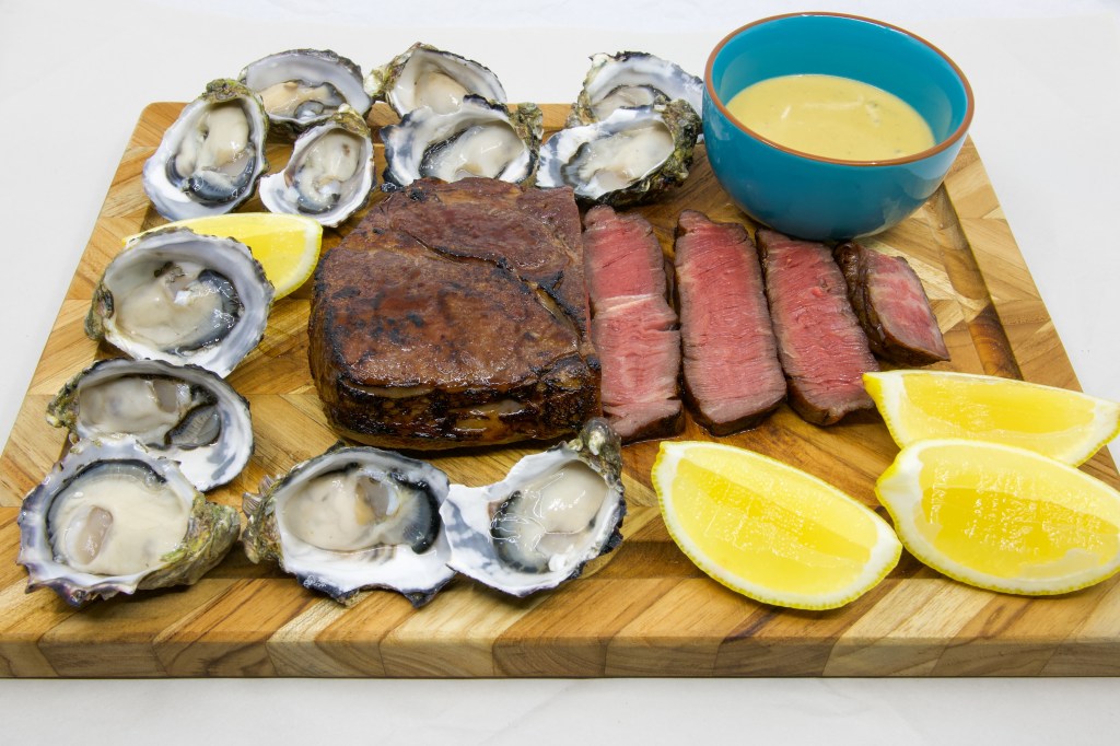 Medium rare grass-fed scotch fillet steak with a dozen fresh oysters and the most umami Vegemite blue vein cheese sauce