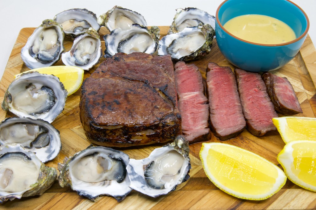 Medium rare grass-fed scotch fillet steak with a dozen fresh oysters and the most umami Vegemite blue vein cheese sauce