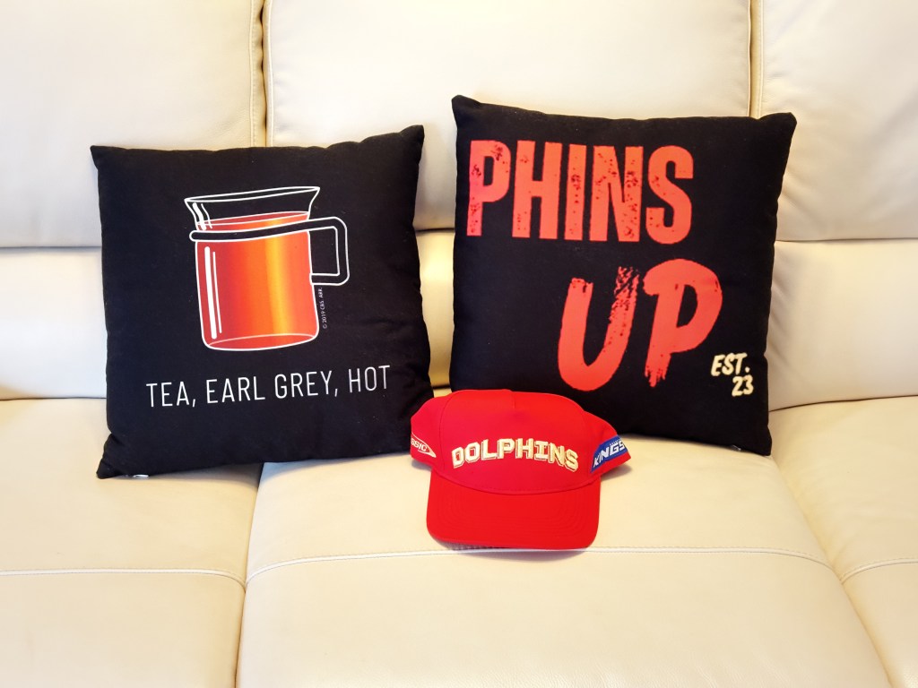 Dolphins NRL Phins Up cushion and a cap
