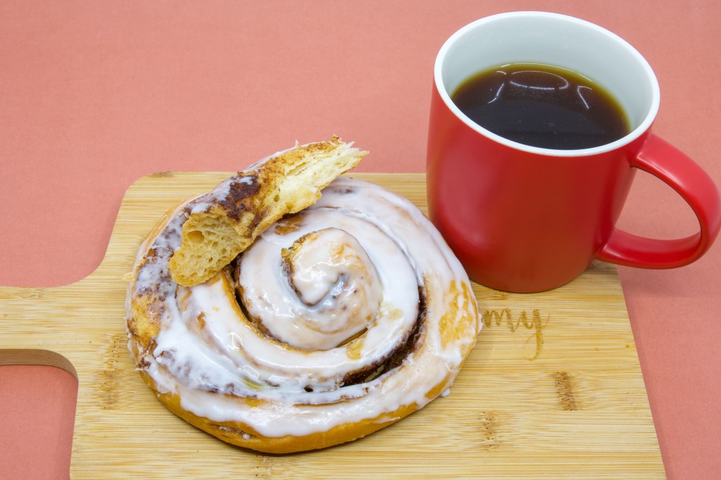 Coffee dunking cinnamon scroll