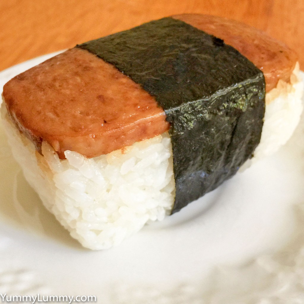 A photograph of Spam Musubi from a holiday in Hawaii in 2015. It is sitting on a white saucer.