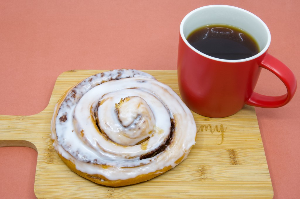 Coffee dunking cinnamon scroll