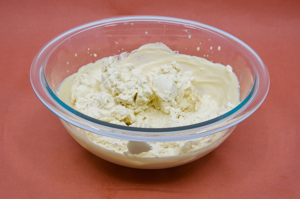 A photograph of freshly whipped Fleurieu Peninsula pure pouring cream in a clear glass mixing bowl
