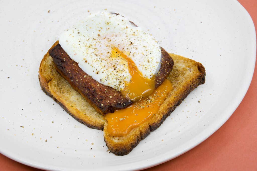 Fried spam and a poached egg on sourdough fried in beef fat