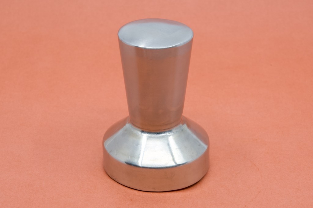 A photograph of a stainless steel coffee Tamper. It's not a butt plug.
