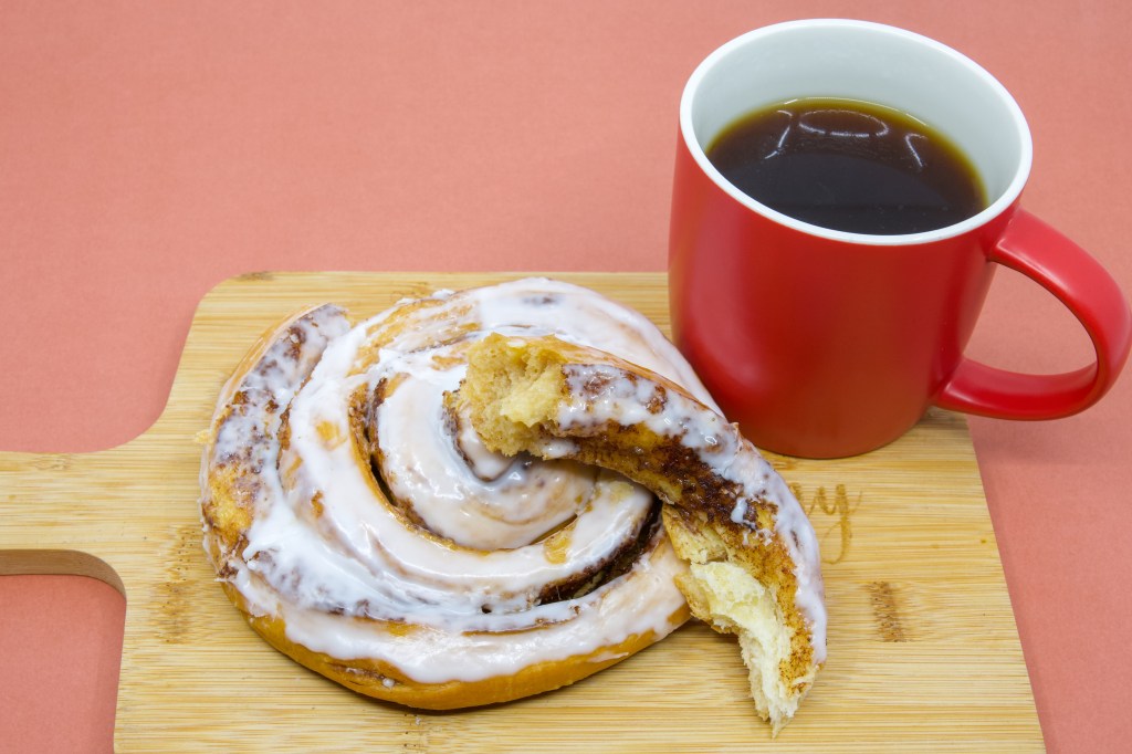 Coffee dunking cinnamon scroll