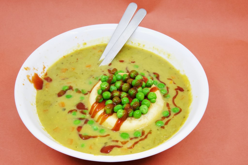 Perryman's Bakery steak and pepper pie floater with Heinz pea and ham soup and Heinz tomato sauce