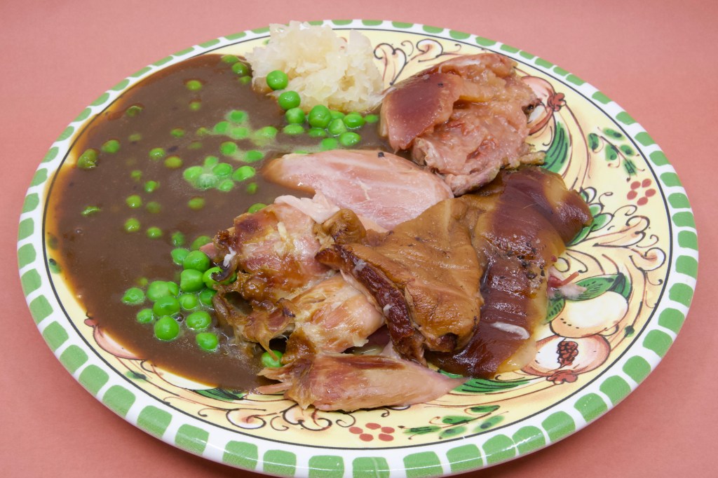 Slow-cooked smoked ham hock and guanciale with sauerkraut, peas, and gravy