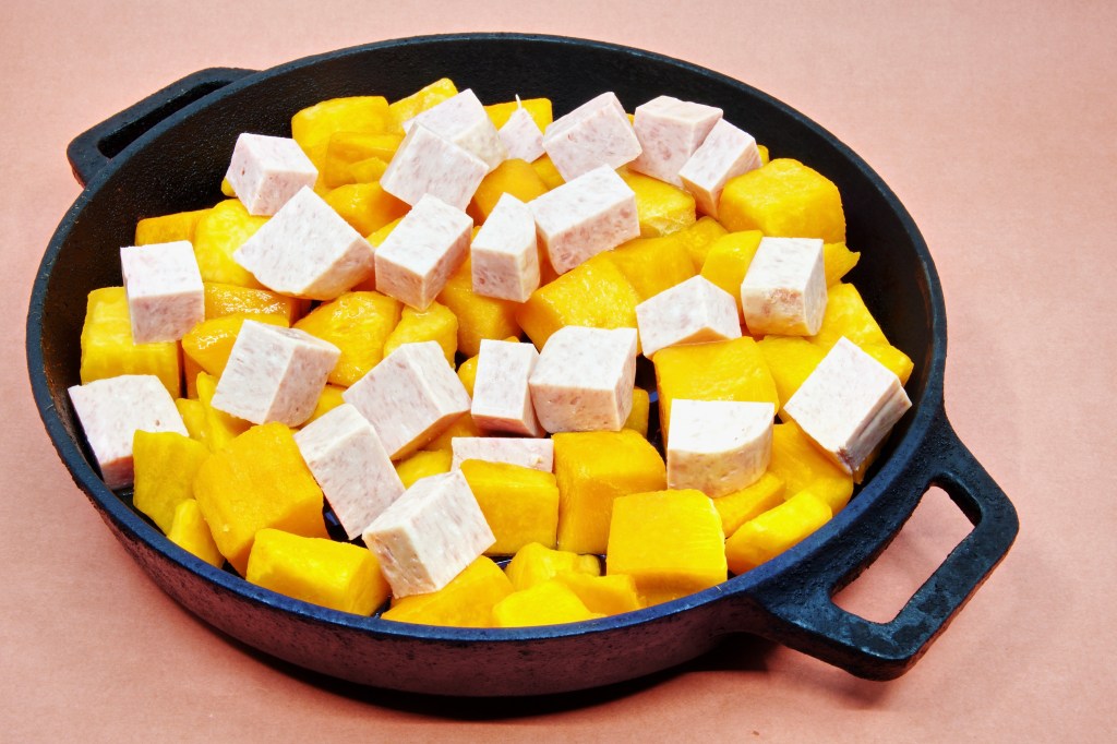 Diced Spam and pumpkin in a cast-iron pan.