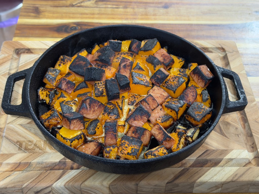 Diced Spam and pumpkin in a cast-iron pan