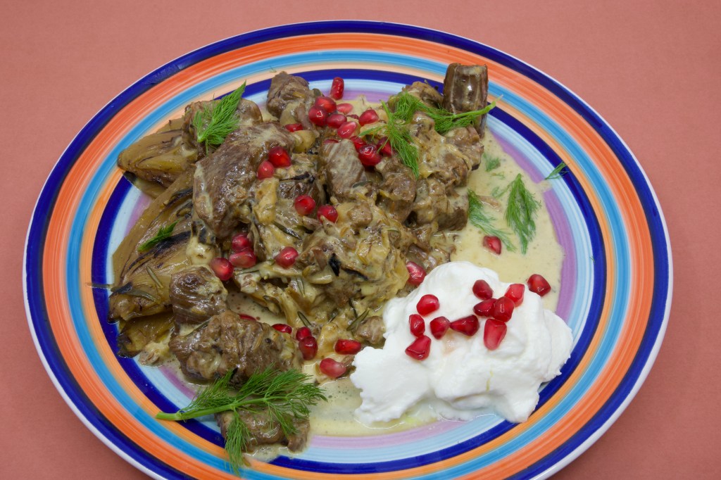 Beef short rib meat cooked in a pressure cooker and served with Greek-style yoghurt garnished with pickled pomegranate arils and fennel fronds.