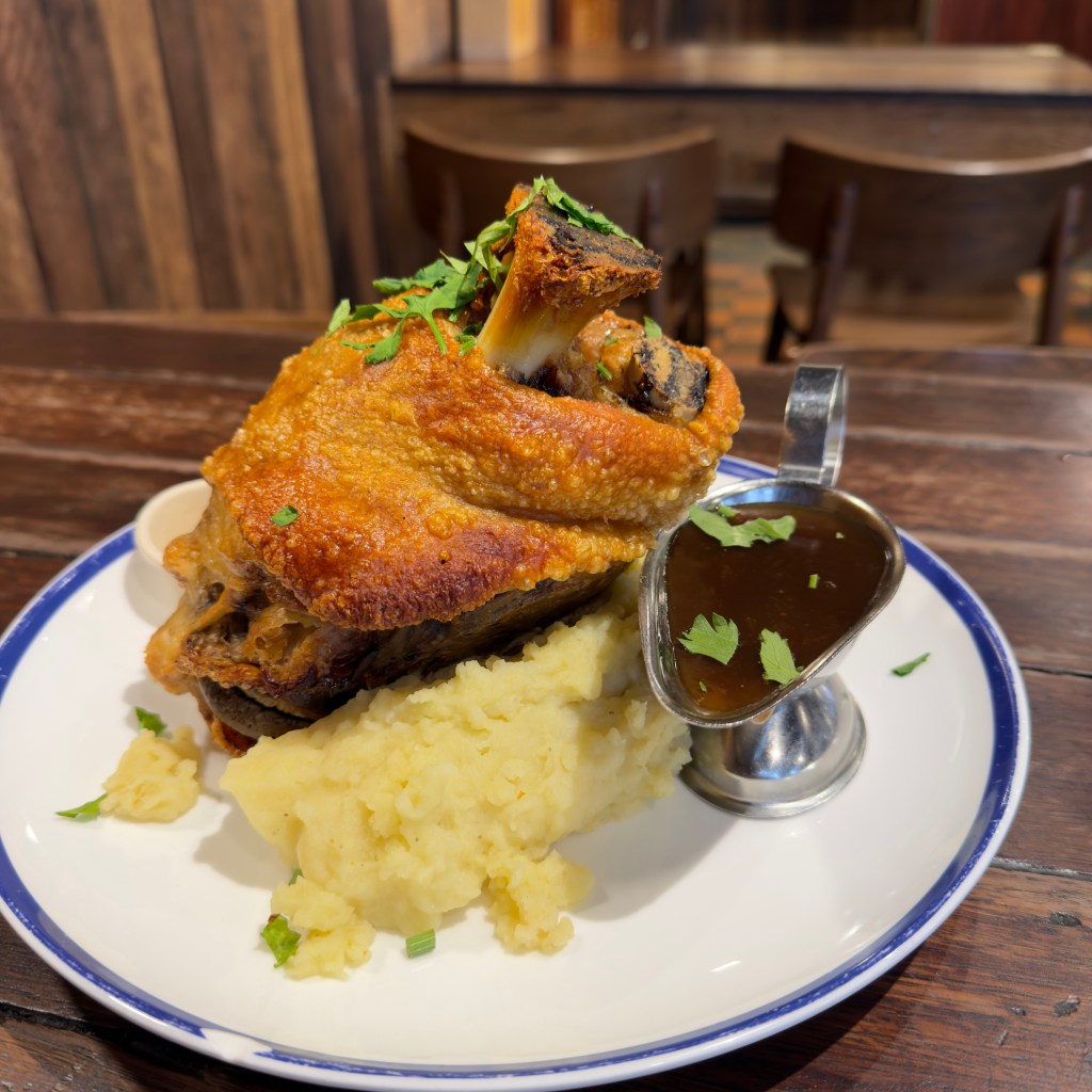 Hahndorf Inn crispy skin pork knuckle, sauerkraut, mustard, mashed potato, and gravy