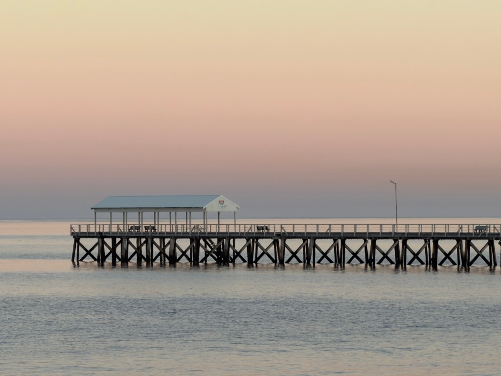 A photograph of the Henley Beach jetty at sunrise.